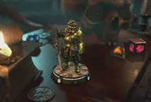 A fantasy warrior figurine from Champions Tactics displayed on a tabletop beside candles and game pieces