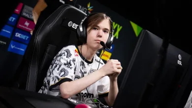 Counter-Strike 2 player donk wearing a headset while seated at a tournament gaming station