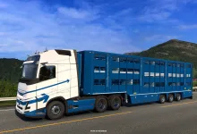 White truck pulling a blue livestock trailer on a mountain road in Euro Truck Simulator 2
