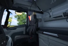 Interior of a Euro Truck Simulator 2 truck cabin showing the driver's seat, dashboard, window, and sleeper area