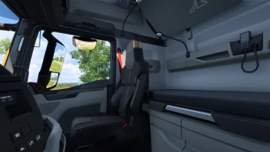 Interior of a Euro Truck Simulator 2 truck cabin showing the driver's seat, dashboard, window, and sleeper area