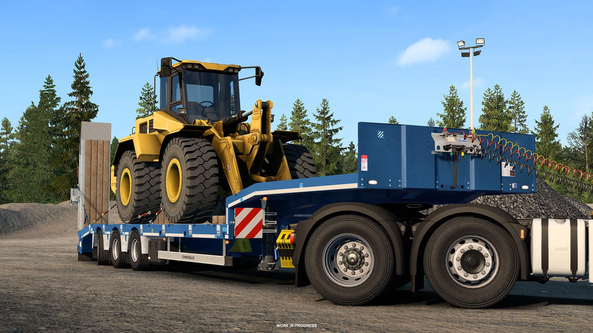 A Schwarzmüller low loader carrying heavy construction equipment