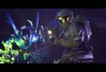 Armored soldier with a glowing visor holds a rifle while facing a brightly colored alien creature in a dark sci-fi setting