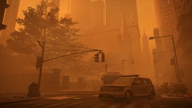 Orange dust storm obscures a New York street with buildings, traffic lights, and vehicles visible through the haze