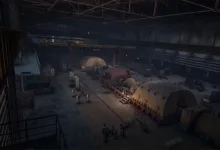 A dark abandoned turbine hall filled with large generators, pipes, railings, and industrial machinery