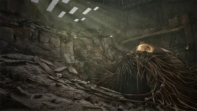 A large damaged metal structure covered in hanging cables sits amid rubble inside a ruined reactor chamber.