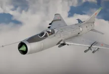 A Soviet Su-7-style fighter-bomber flies through clouds with missiles mounted beneath its wings.