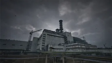 A damaged concrete reactor complex with a tall exhaust stack, construction crane, and industrial pipes beneath dark storm clouds
