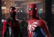 Two Spider-Man characters, one in a red-and-blue suit and one in a black-and-red suit, stand indoors