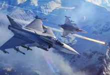 Two fighter jets fly over snowy mountains as one launches a missile