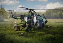 War Thunder helicopter parked in a grassy field with two people beside it