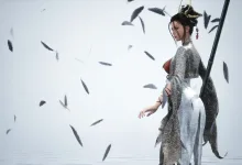 A female warrior in ornate gray clothing stands amid falling feathers against a pale background