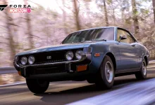 A blue 1974 Toyota Celica GT driving through a forest in Forza Horizon 6