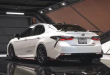Rear three-quarter view of the white 2023 Toyota Camry TRD in Forza Horizon 5.