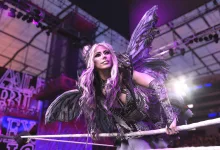 Alexa Bliss in dark moth-inspired gear with wings inside a WWE 2K26 wrestling ring