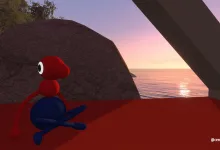 A red-and-blue Big Walk character sits on a rocky overlook above the sea at sunset.