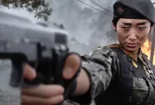A Call of Duty: Modern Warfare 4 soldier aims a pistol in a smoky urban setting.