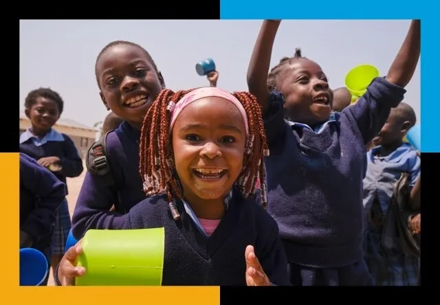Children smiling during a school meal program