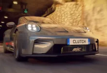 A gray sports car marked Clutch driving through a tunnel