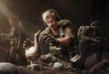 Three Delta Force operators gather around equipment, with a blond operator crouching in the center.