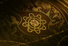 Close-up of the gold The International emblem on ornate Dota 2 event artwork