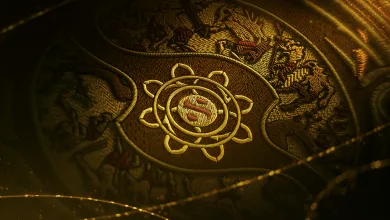 Close-up of the gold The International emblem on ornate Dota 2 event artwork