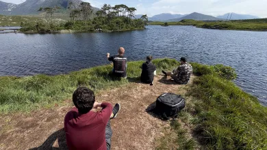 Members of the Euro Truck Simulator 2 map team sit beside a lake during their Ireland research trip.