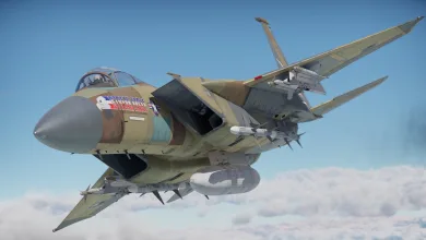 A fighter aircraft carrying multiple missiles flies above the clouds