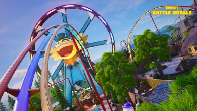 Fortnite amusement park area with looping roller coaster tracks, a large yellow sun-shaped decoration, trees, and buildings