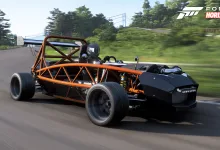 A stripped-down orange-and-black kit car driving on a track in Forza Horizon 6
