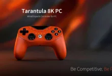 Orange GameSir Tarantula 8K PC wired controller against a blurred orange and black background