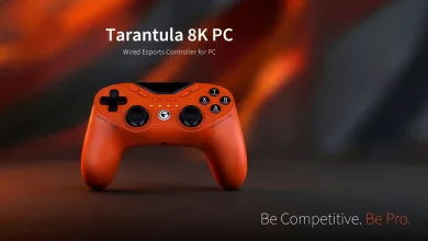 Orange GameSir Tarantula 8K PC wired controller against a blurred orange and black background