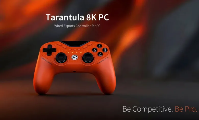 Orange GameSir Tarantula 8K PC wired controller against a blurred orange and black background