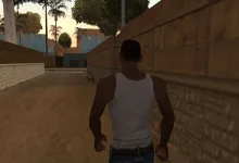 A character in a white tank top walks through an alley in Grand Theft Auto: San Andreas.