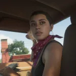 A woman wearing a red bandana sits inside a car with a city street visible through the windows.