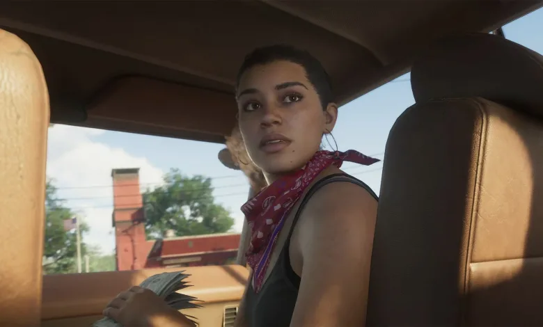 A woman wearing a red bandana sits inside a car with a city street visible through the windows.