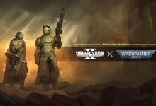 Two armored Helldivers stand in a smoky battlefield beneath the Helldivers 2 and Warhammer 40,000 logos.