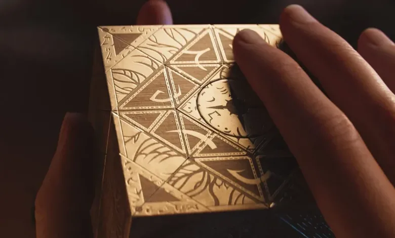 Hands hold the ornate Genesis Configuration puzzle box from Hellraiser: Revival