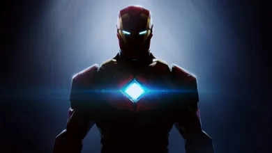 Iron Man stands in shadow with glowing blue eyes and a bright blue arc reactor.