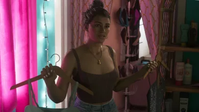 Lucia holds a clothes hanger in a brightly lit room in Grand Theft Auto VI