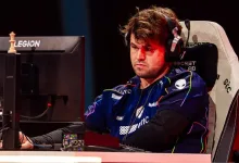 Magnus Carlsen wearing a Team Liquid jersey and headset at a chess esports station