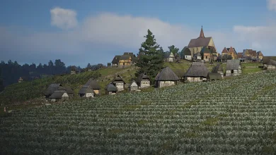 A medieval Manor Lords settlement with a church and houses on a cultivated hillside beneath a blue sky