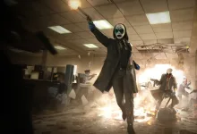 A masked PAYDAY 3 heister walks through a damaged bank during a robbery