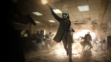A masked PAYDAY 3 heister walks through a damaged bank during a robbery