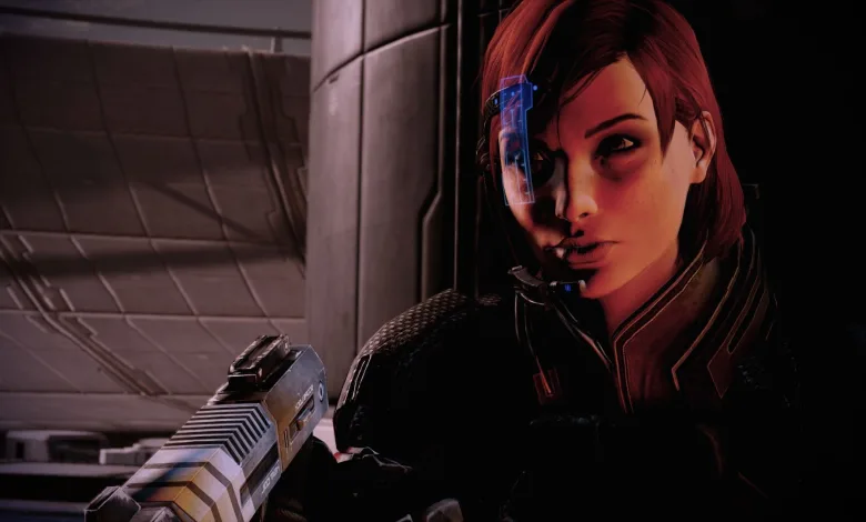 A red-haired Mass Effect character holding a rifle inside a futuristic interior.