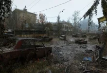 A rain-soaked ruined street filled with abandoned cars, overgrown debris, and damaged buildings in METRO 2039.