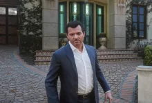 Michael from Grand Theft Auto V standing outside a house