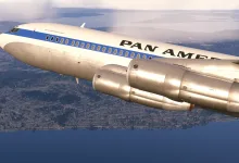 A Pan Am Boeing 707 flies over a coastal city and waterfront in Microsoft Flight Simulator 2024.
