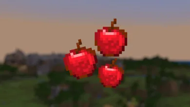 Three pixelated red Minecraft apples floating above a blurred landscape
