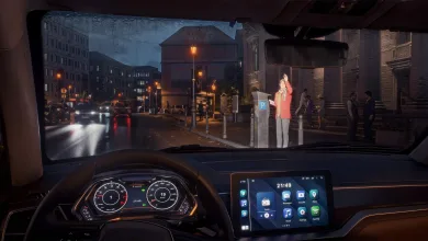 A driver views a rainy city street from inside a car in Rideshare Stimulator.